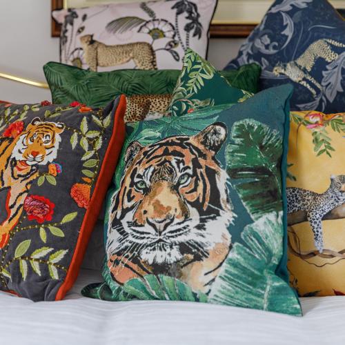 a pile of pillows with tigers on them on a bed at Georgina in Lavenham
