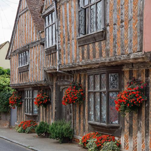 an old building with flowers in front of it at Georgina in Lavenham
