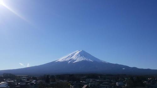 a view of a snow covered mountain in a city at Lakeland Hotel Mizunosato in Fujikawaguchiko