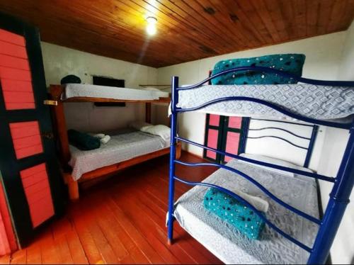 a room with three bunk beds in a boat at Ecolife Calima in Calima