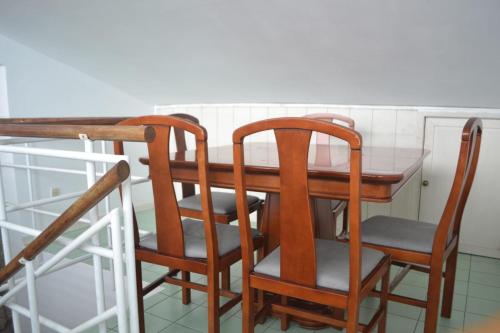 a dining room table with two chairs and a table at Casa Augusta AL in Braga