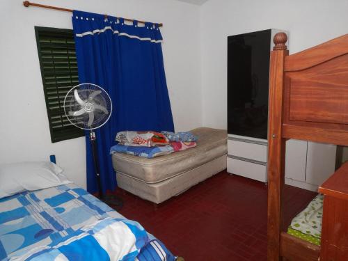 Schlafzimmer mit einem Bett, einem Ventilator und einem Fenster in der Unterkunft ESTANCIA VIEJA (CARLOS PAZ) in Estancia Vieja