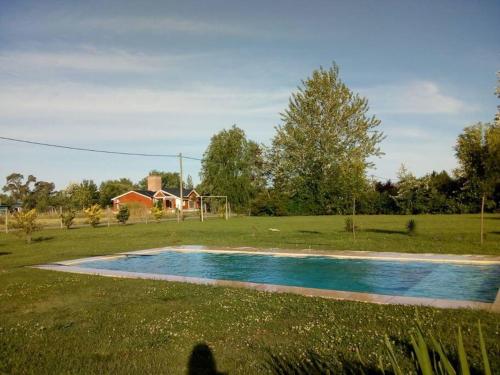 a swimming pool in a field with a soccer ball at Casa quinta en Mercedes, Bs As in Mercedes