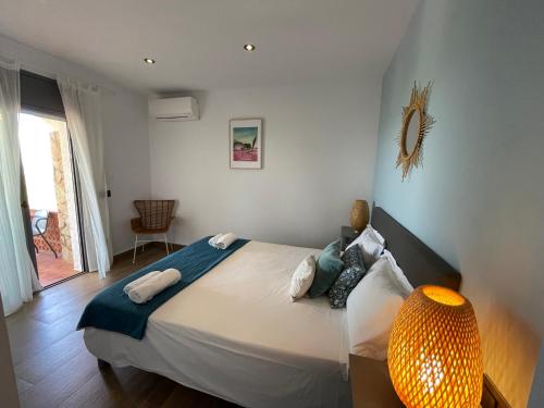 ein Schlafzimmer mit einem großen Bett und einer Lampe in der Unterkunft Ty Pals in Pals