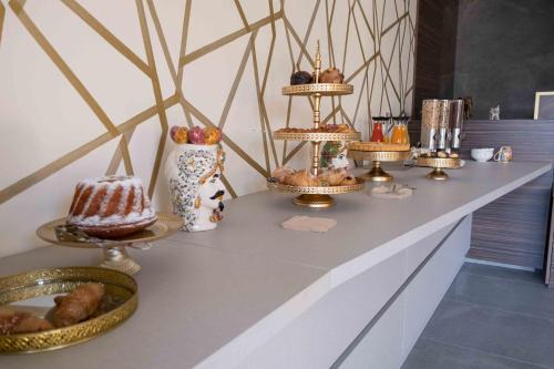a buffet with cakes and other desserts on display at Divina Charme in Mascalucia
