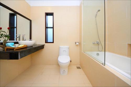 y baño con aseo, lavabo y ducha. en Green Areca villa, en Hoi An