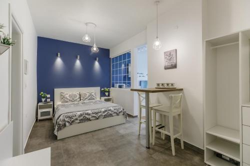 a bedroom with a bed and a table in a room at NAVA Apartment in the center of Thessaloniki in Thessaloniki