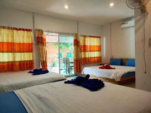 a bedroom with two beds and a window at Sweet Time Bungalows in Koh Rong Sanloem