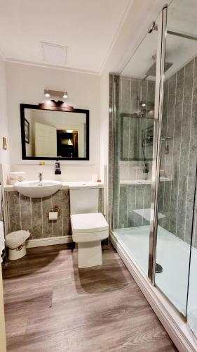 a bathroom with a sink toilet and a shower at Muthu Belstead Brook Hotel in Ipswich