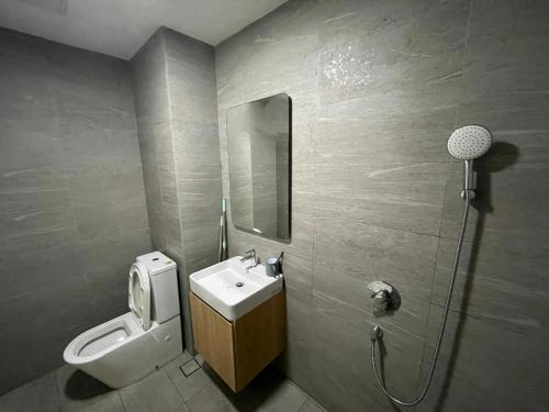 a bathroom with a sink and a toilet and a mirror at Pavilion 2 Revo l Rooftop Swimming Pool LS15 in Kuala Lumpur