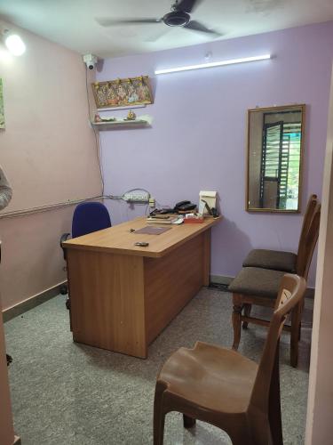 an office with a desk and a chair and a mirror at French Park Inn in Puducherry
