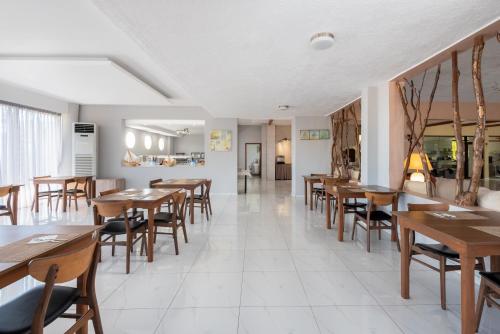 a dining room with wooden tables and chairs at Afandou Blu in Afantou