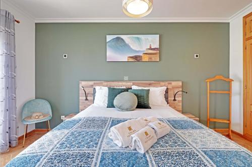 a bedroom with a bed with two pillows on it at Villa Acoteias - By Dalma Portuguesa in Olhos de Água