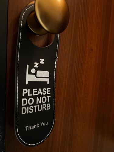 a sign on a door that says please do not disturb at B&B Room Code 1 in Frosinone