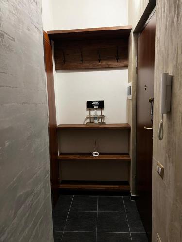 a small room with a door and a shelf at B&B Room Code 1 in Frosinone