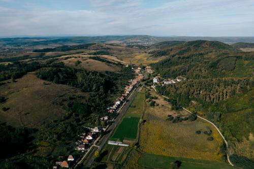 an aerial view of a town in the hills at Vidéki vendégház a Bükkben, pezsgőfürdővel. in Királd