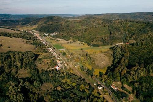 an aerial view of a road in a forest at Vidéki vendégház a Bükkben, pezsgőfürdővel. in Királd
