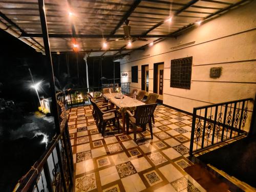 a patio with a table and chairs on a balcony at Rane's Ambadnya Niwas in Nagaon