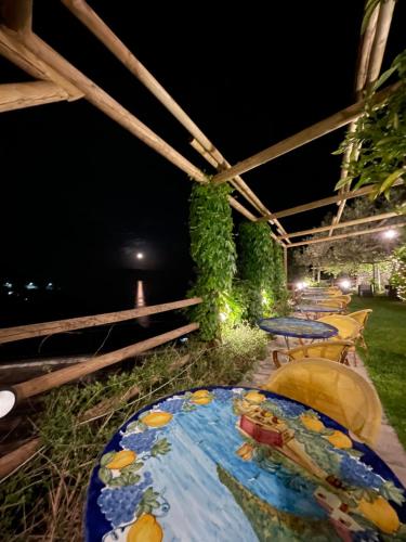 a table with a plate of food on a patio at Fico D'India Relais in Furore