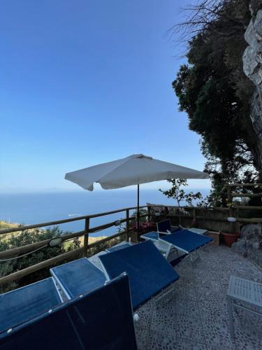 a group of blue chairs and an umbrella at Fico D'India Relais in Furore