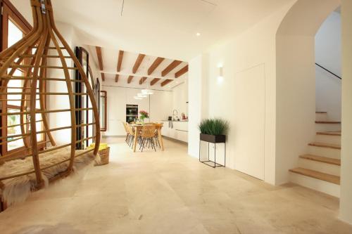 a hallway with a staircase and a dining room at Can Xiprers in Pollença