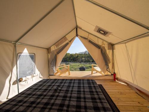 a tent with a checkered rug inside of it at Tentrr Signature Site - Texas 1873 in May