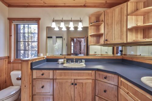 a bathroom with a sink and a mirror at Cranberry Cove Lodge in Eagle River