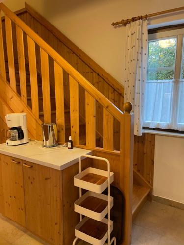 a kitchen with a counter and a staircase at Am Herrensee in Litschau
