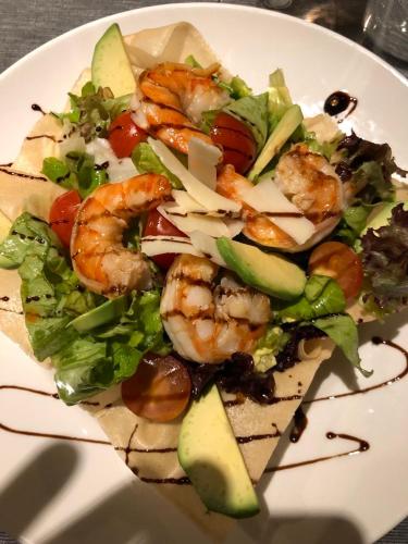 a salad with shrimp and vegetables on a white plate at All Seasons Residence Design Hotel - Free parking in Sofia