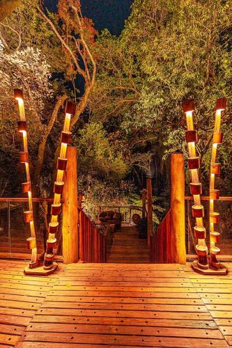 a wooden walkway with lights on top of it at Confraria Colonial Hotel Boutique in Mairinque