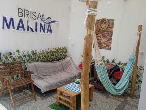 a living room with a hammock and a couch at Hostal Brisa Marina in Paracas