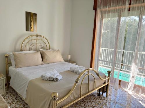 a bedroom with a bed with towels on it at Sorrento's Carme family big appartament in Sorrento
