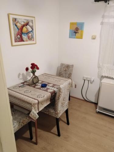 a table and two chairs in a room at Lara in Sombor