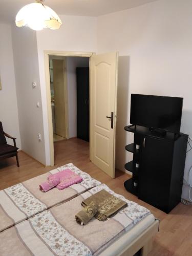 a room with a bed with two towels on it at Lara in Sombor
