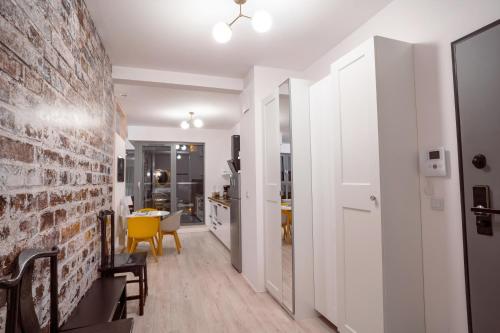 a kitchen and dining room with a brick wall at CLASSY APARTMENTS - Gdańsk - Widok z Wyspy in Gdańsk