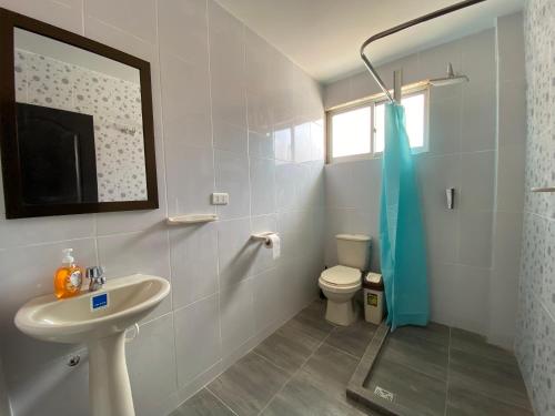 a bathroom with a sink and a toilet and a shower at Agradable departamento con estacionamiento gratis in Sucre
