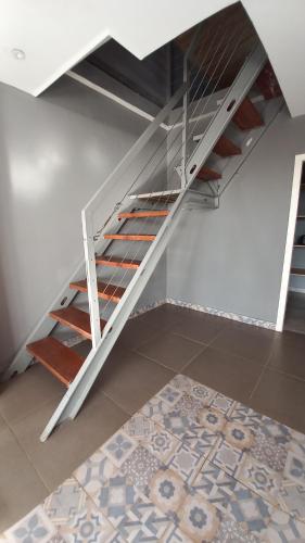 a white staircase in a room with a rug at Tropicana Beach & Resort in Elwa