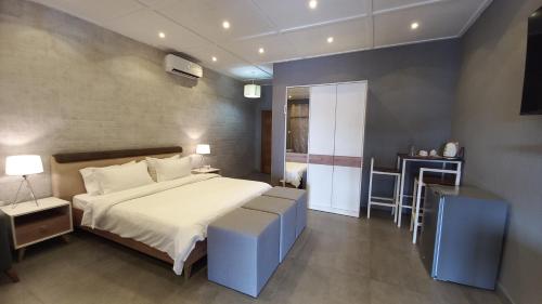 a bedroom with a bed and a table in a room at Tropicana Beach & Resort in Elwa