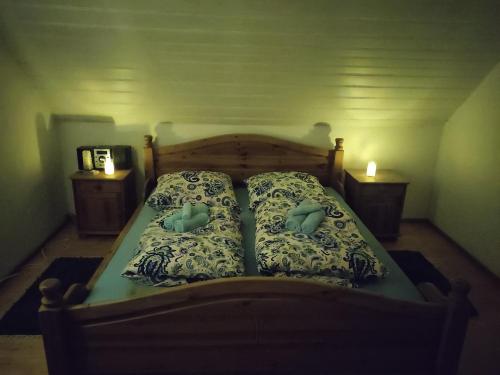 a bed in a room with two pillows on it at Zimmer Veljanovski in Blaufelden