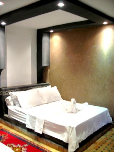 a hotel room with a bed with a towel on it at Hotel Restaurant La Kasbah in Tinerhir