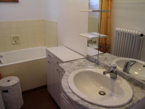 a bathroom with a sink and a bath tub at Appartement La Clusaz, 3 pièces, 6 personnes - FR-1-459-43 in La Clusaz