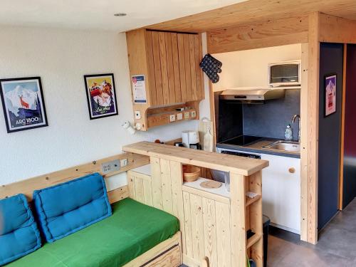 - une petite cuisine avec un banc et un comptoir dans l'établissement Duplex rénové au calm, proche des pistes avec balcon sud – Arc 1800 - FR-1-346-515, à Arc 1800