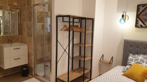 La salle de bains est pourvue d'une douche et d'une cabine de douche en verre. dans l'établissement Superbe Maison 68m2 avec Cour -Hypercentre Avignon, à Avignon