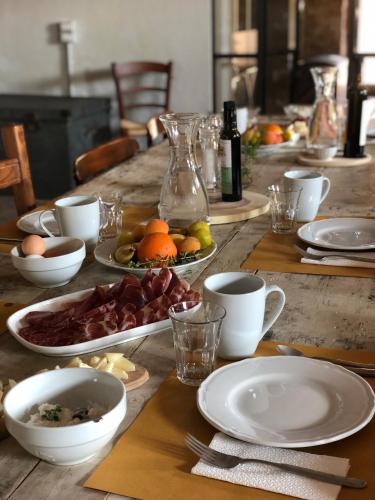 a wooden table with plates of food on it at La Fattoria del Rio di Sopra - Agriturismo Baldeschi in Tuoro sul Trasimeno