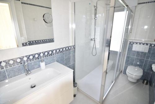 a bathroom with a tub and a shower and a sink at Dream Villa in Benidoleig