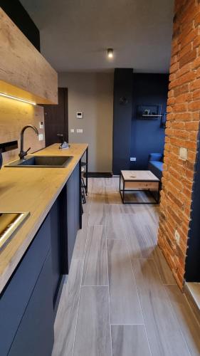a kitchen with a sink and a couch in a room at Apartman WINTER in Pale