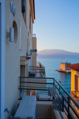 a balcony with benches and a view of the water at Vip Lepanto Castle Suites in Nafpaktos