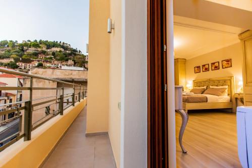 a room with a bed and a balcony at Vip Lepanto Castle Suites in Nafpaktos