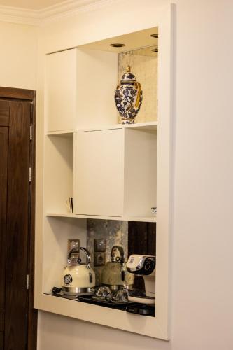 a kitchen with white cabinets and a stove top oven at Vip Lepanto Port Suites in Nafpaktos