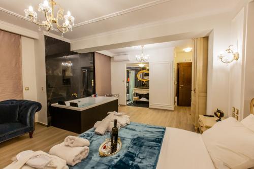 a room with a bath tub and a bottle of champagne at Vip Lepanto Port Suites in Nafpaktos